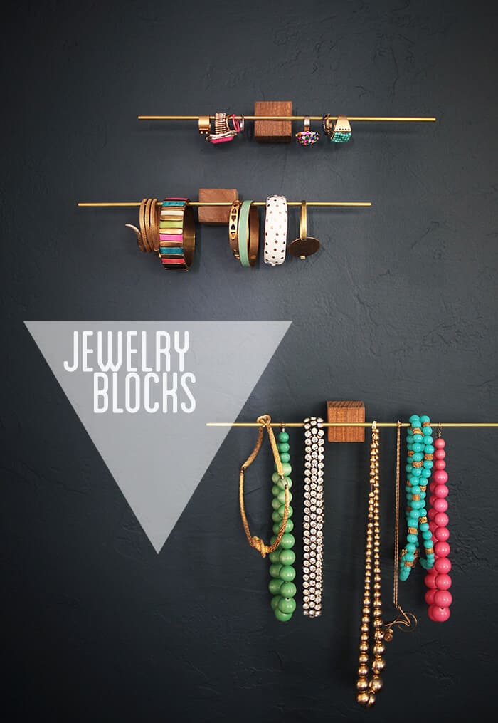 Thin metal rods adhered to wooden blocks becomes a stunning modern designed jewelry holder.