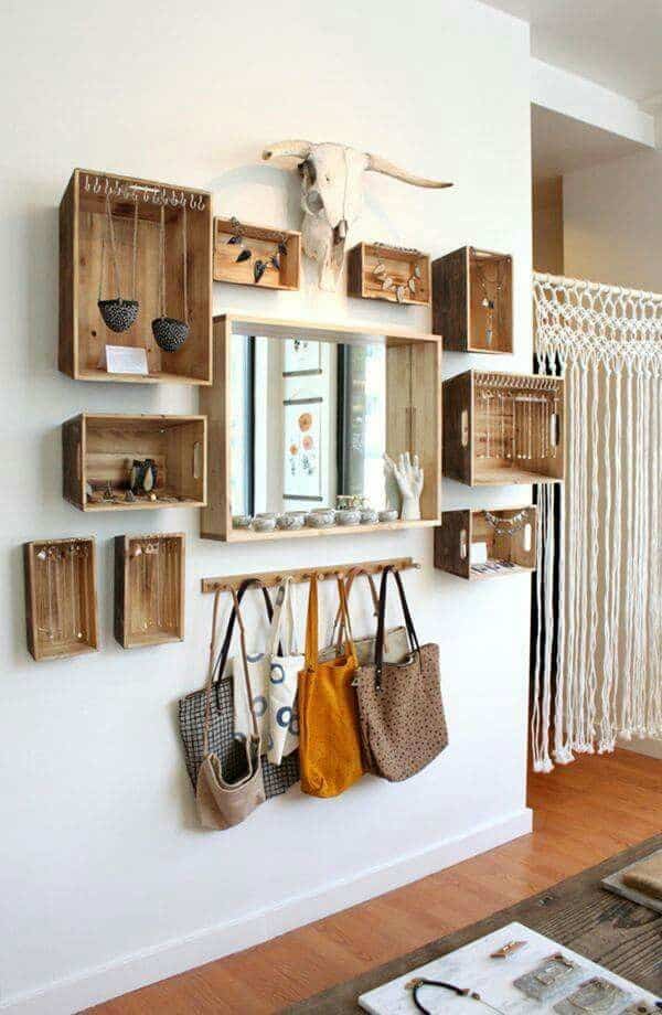 a blank wall becomes a beautiful and functional organization system with hanging wooden boxes with hooks for hanging necklaces, purses, and jewelry