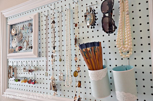 a pegboard is transformed into a jewelry and accessories organizer with strategically placed hooks for necklaces, earrings, and sunglasses