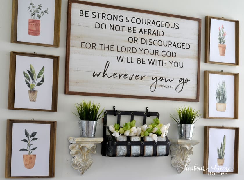 Spring wall arrangement above a couch with free printable plant art.