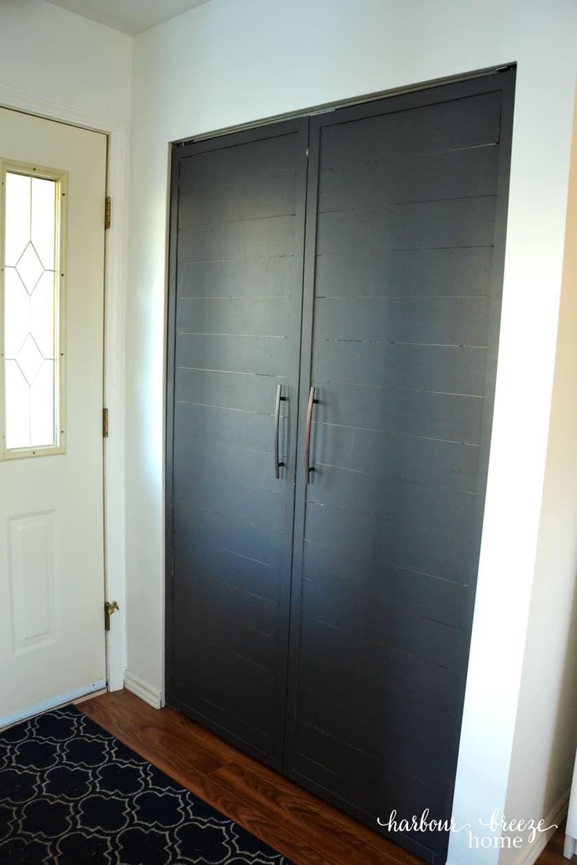 Bifold closet doors turned into shiplap french doors in a small hallway entryway closet