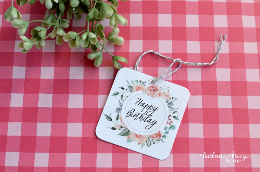 Loop baker's twine or string through the hole in the tag so it's ready to tie onto a package.