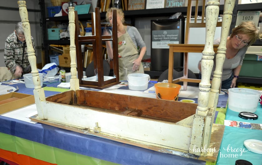 a desk sitting on a table upside down ready to be painted