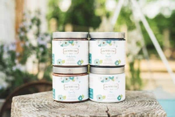 picture of country chic products in jars sitting on a wooden stump