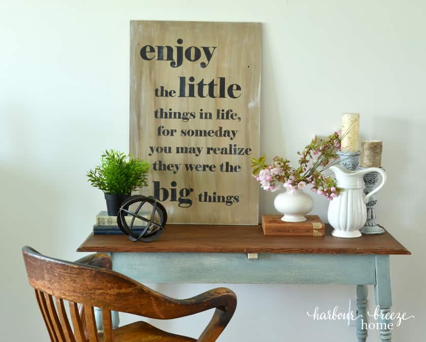 a wood and blue farmhouse table with an oak office chair sitting in front