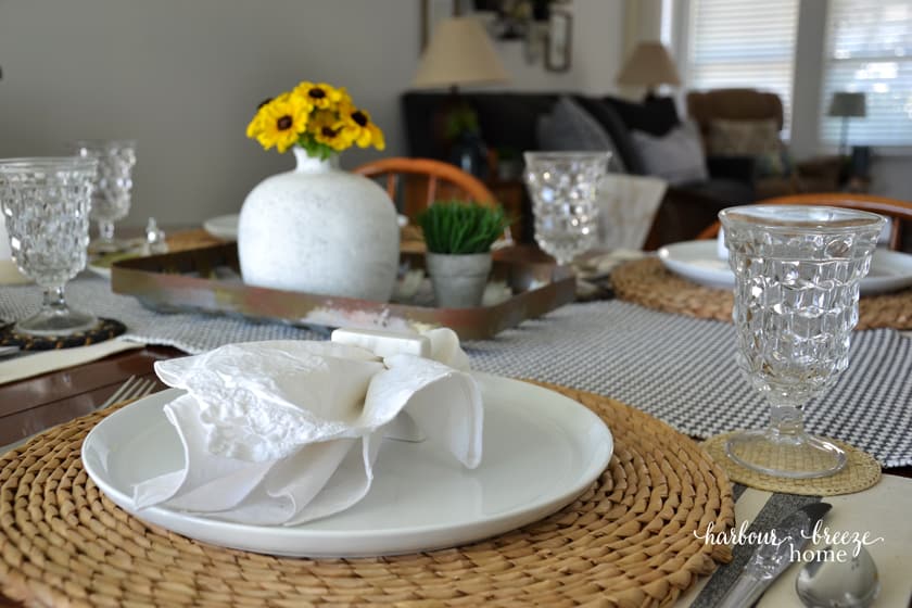 A table set with the living room in the background