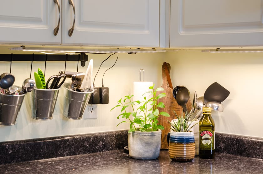 Corner of kitchen with under the cabinet LED light strip turned on.