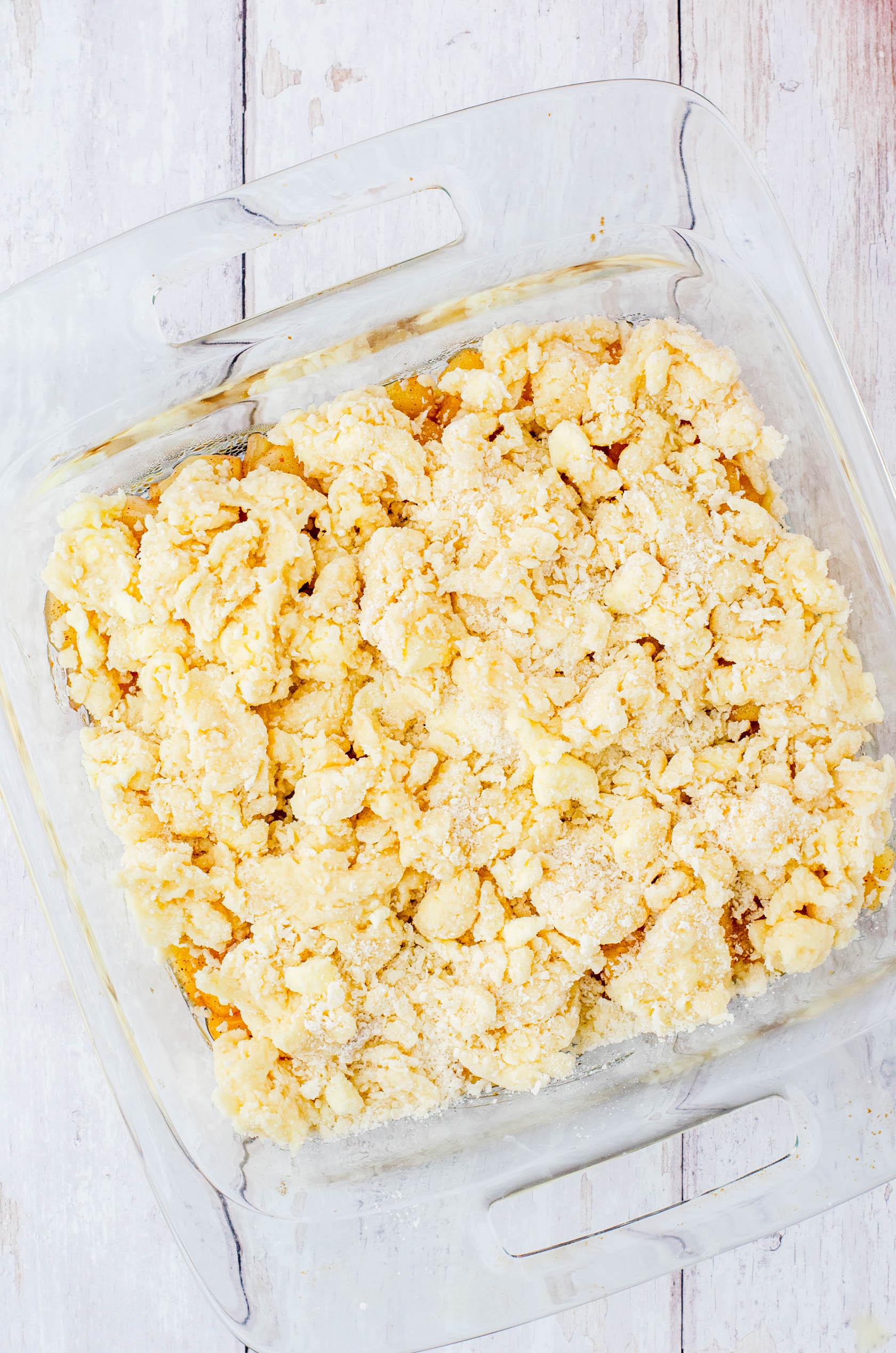 A pan of apple cobbler ready to be put in the oven to bake.