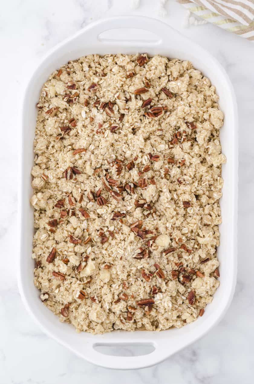 Apple crisp with apple pie filling in a 9x13 inch pan ready to be baked.