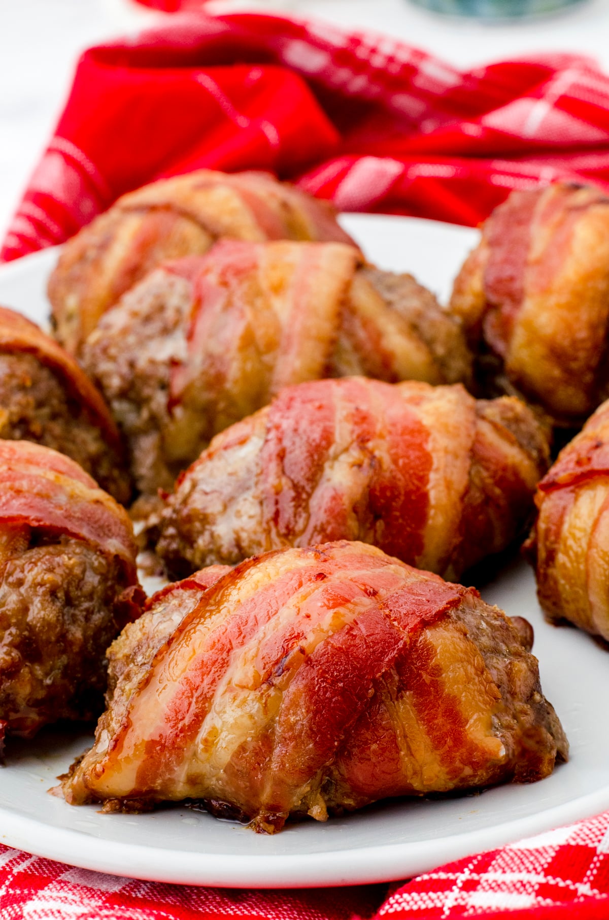 Bacon wrapped meatloaf on a serving platter.