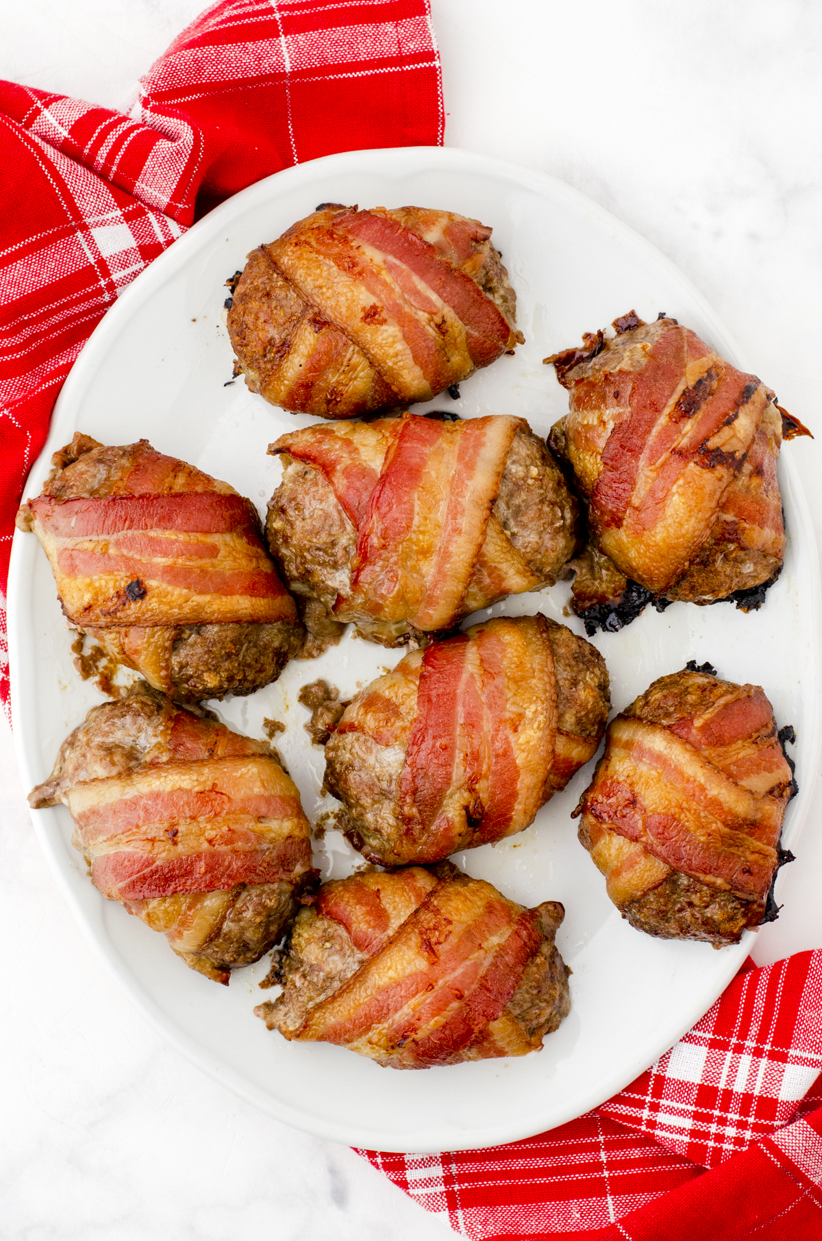 A platter of bacon wrapped mini meatloaf