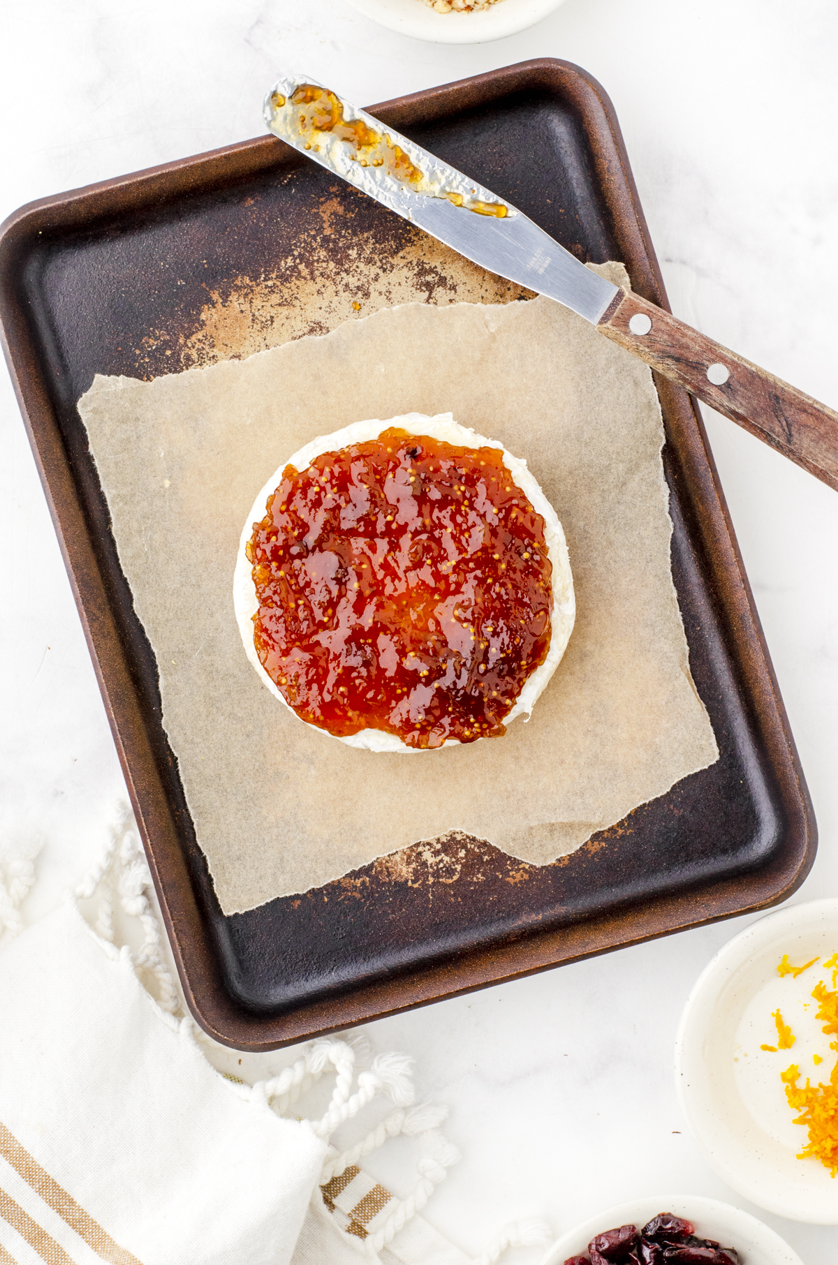 round of brie with fig jam spread on the top of it