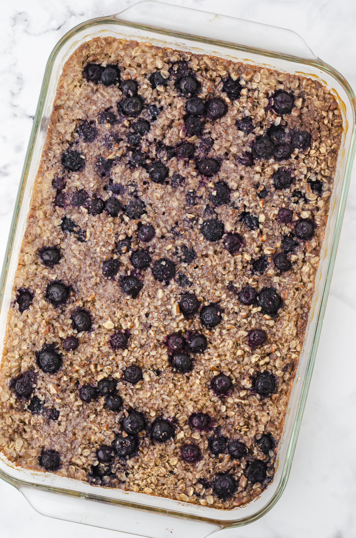 A pan of baked oats with bananas and blueberries.