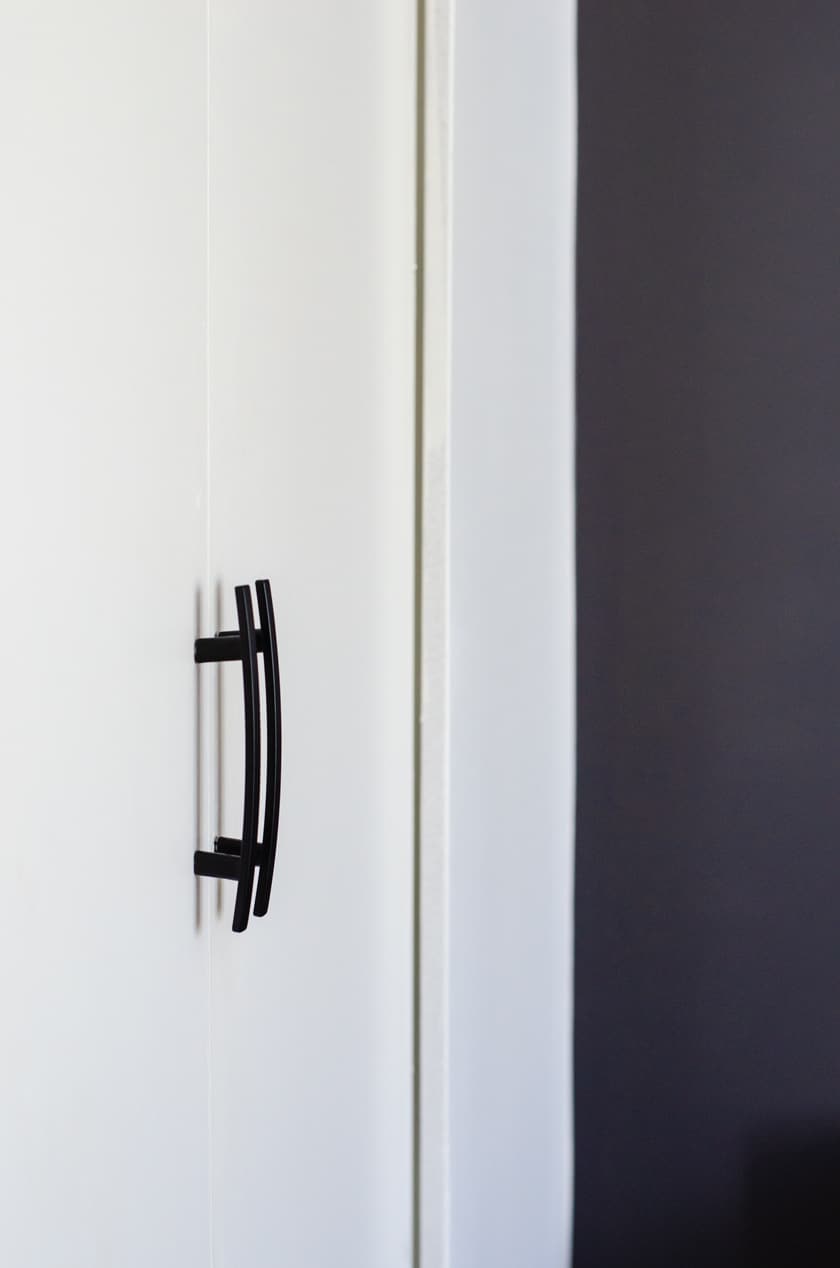 Close up of 2 modern door pulls on bi-fold closet door