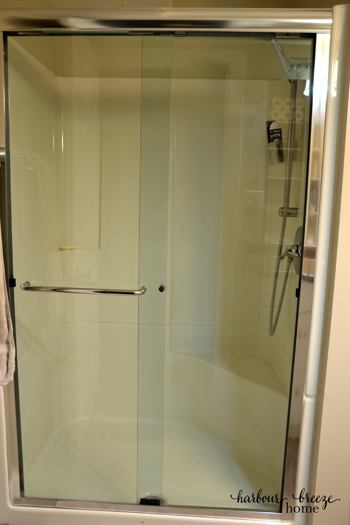 a clean shower door after it has been rinsed of the cleaner and dried off