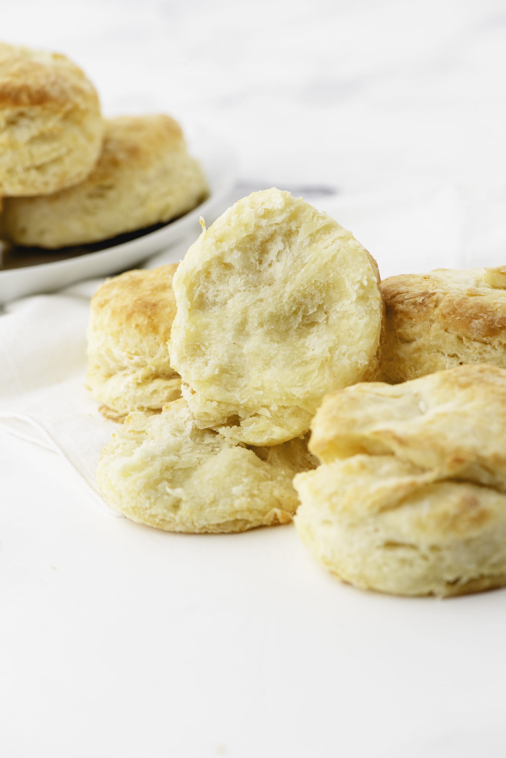 A light and fluffy baking powder biscuit split in half to reveal what the inside looks like.