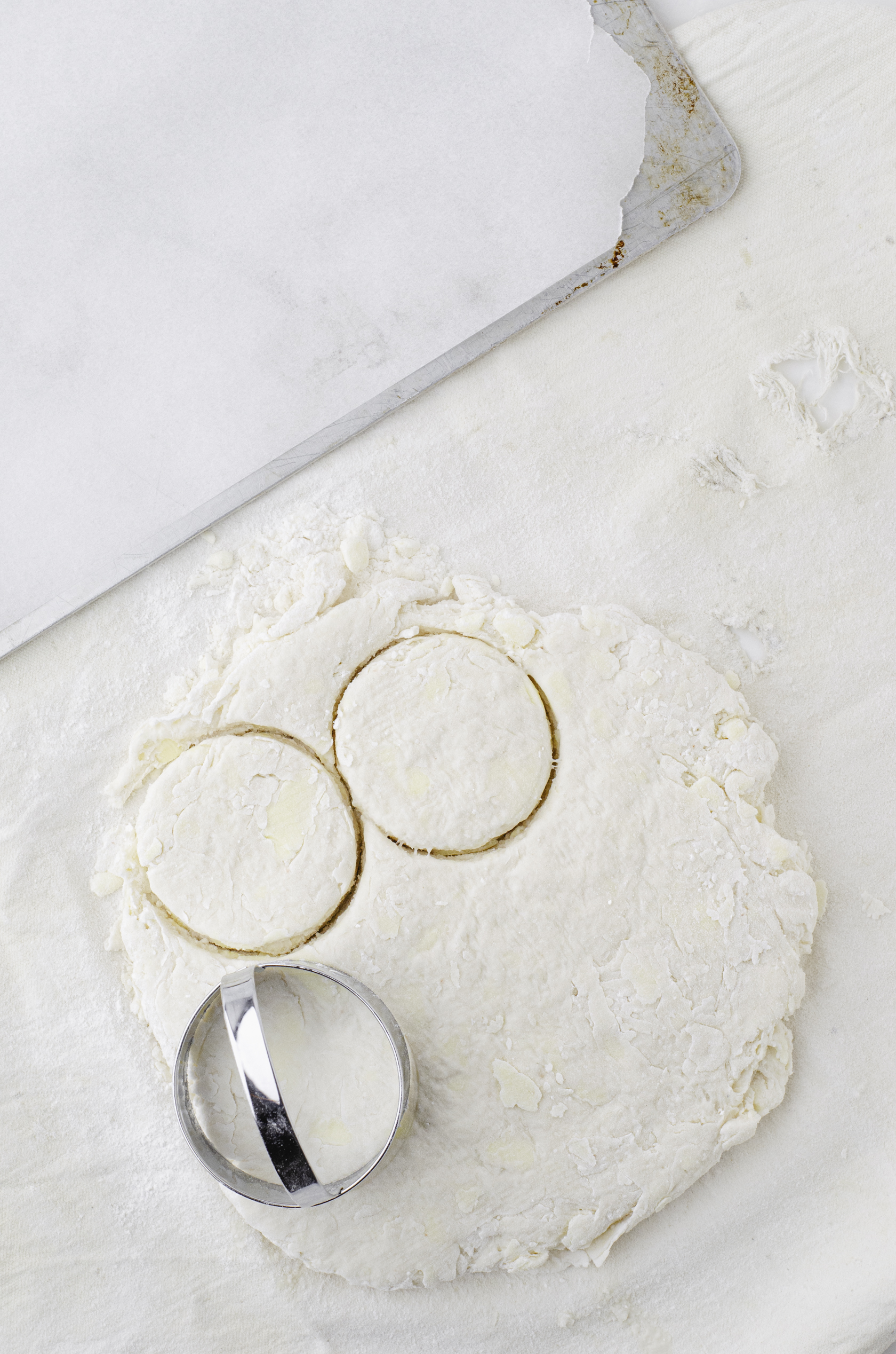 biscuit dough with biscuit cutter sitting on top of it