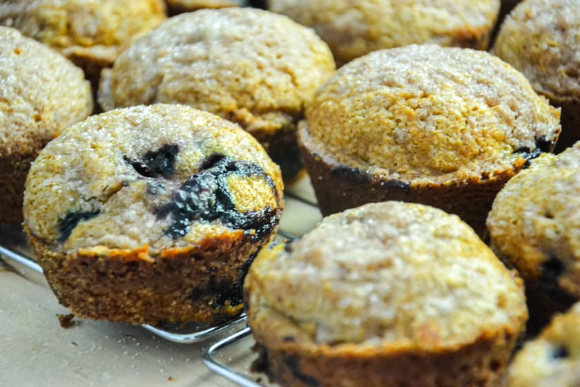 Pumpkin blueberry struesal muffins cooling on a wire cooling rack.