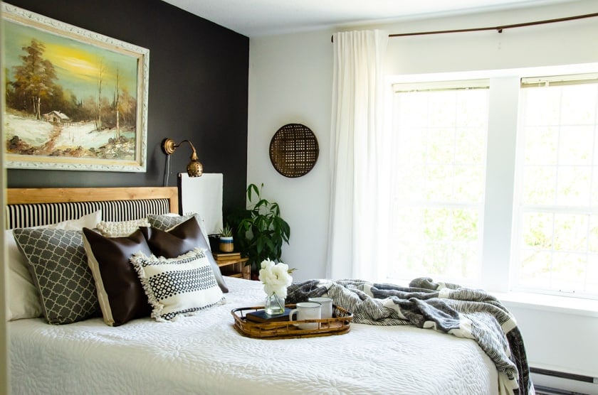 Boho bedroom featuring a black accent wall.