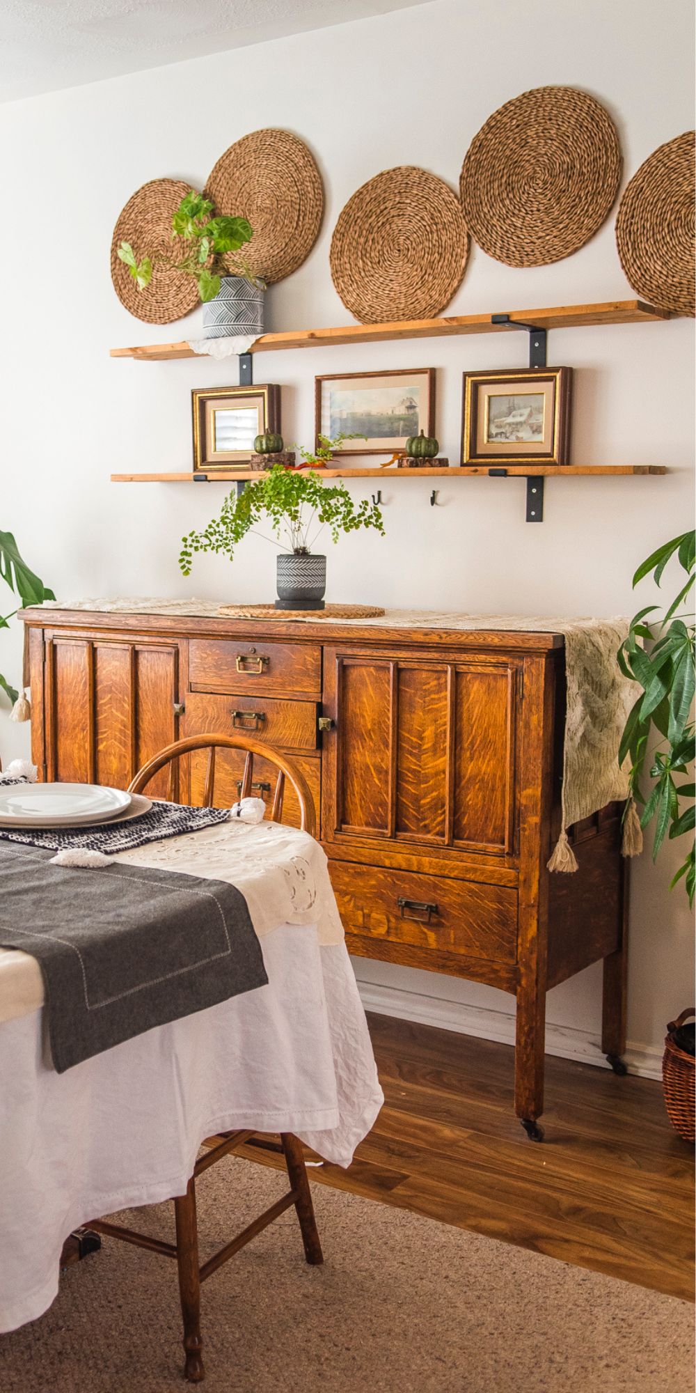 Antique buffet with farmhouse shelves above it decorated with boho style fall decor
