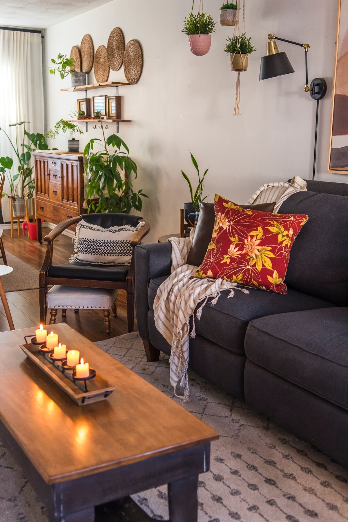 fall pillow cover on a couch with candles on a coffee table in front of it for a boho fall decor look