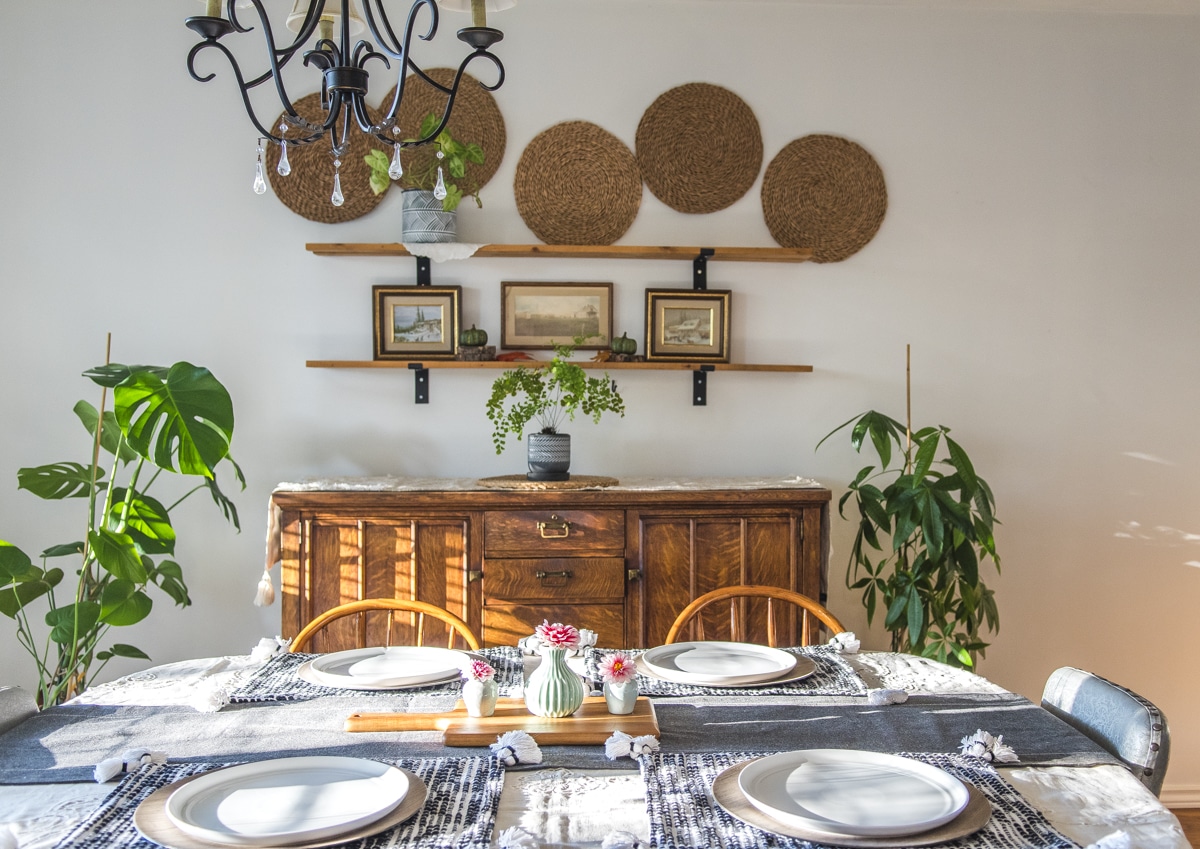 Dining room with boho casual fall shelf decor above an atique buffet
