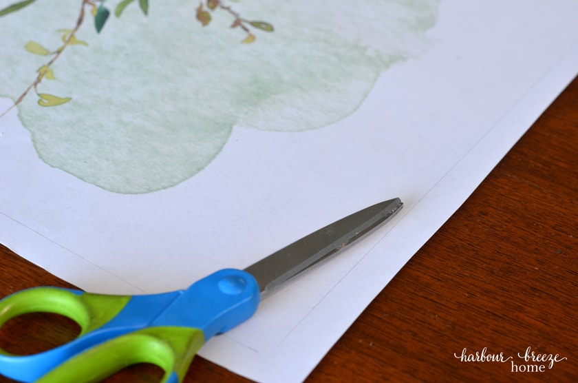 trimming the free printable flower art print to fit the diy picture frame