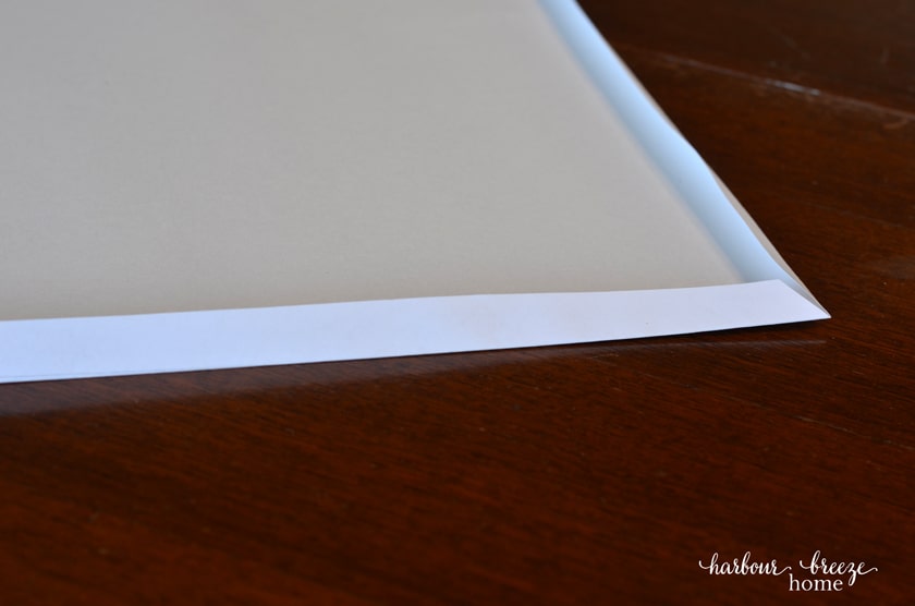 Folding the corners of a free printable art engineer print around a sturdy sheet of poster board