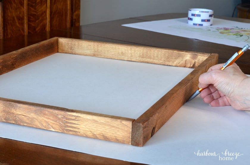 drawing around the edge of a diy picture frame to get the correct measurement for the poster board