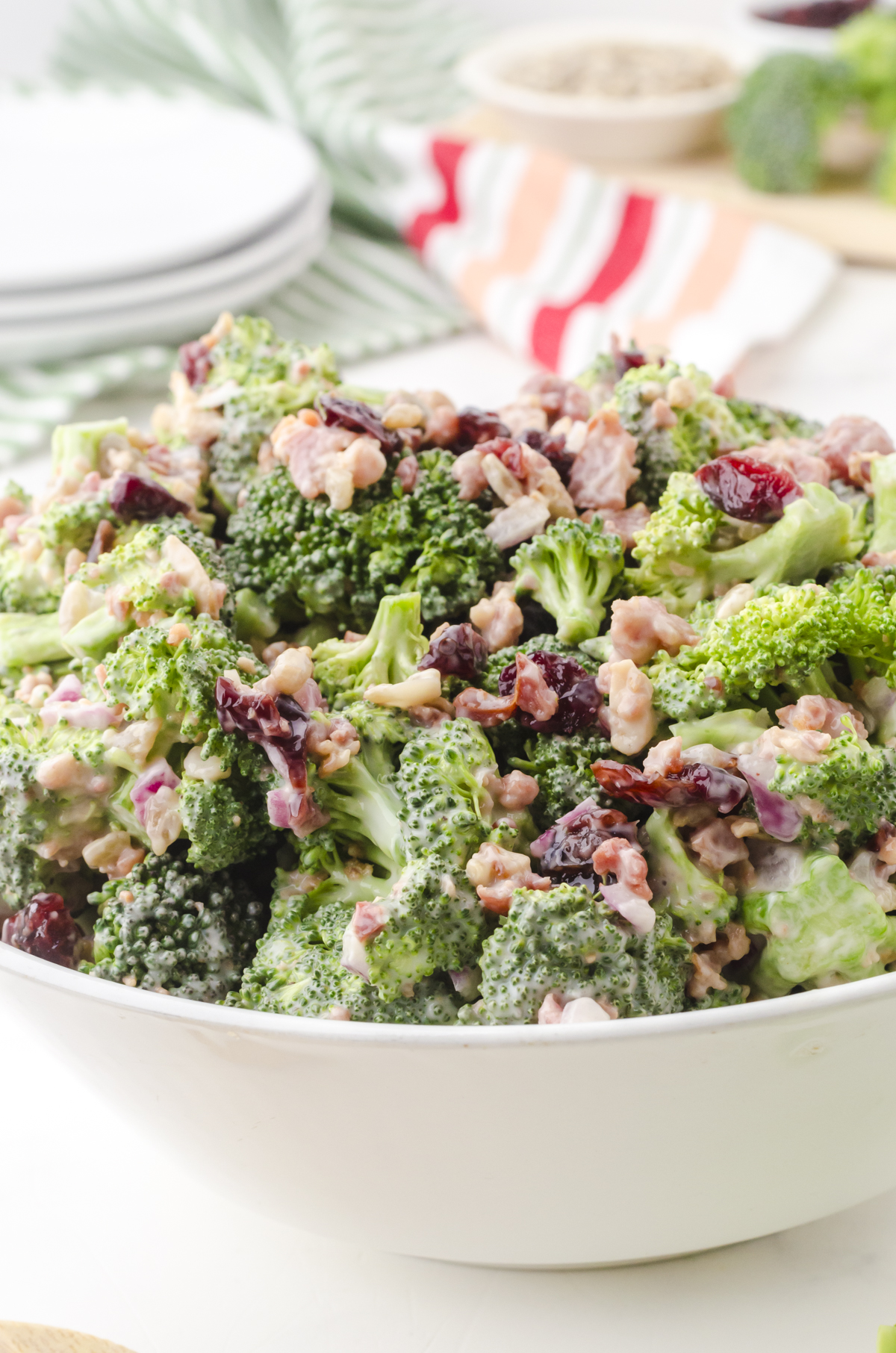 A bowl of broccoli salad with cranberries, miracle whip and bacon