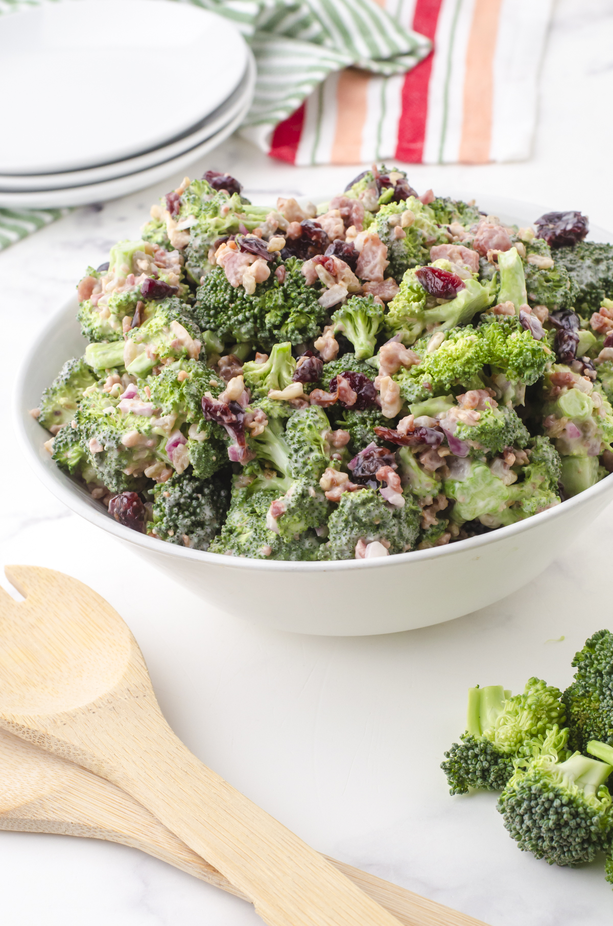 bowl of broccoli sald with cranberries and bacon bits