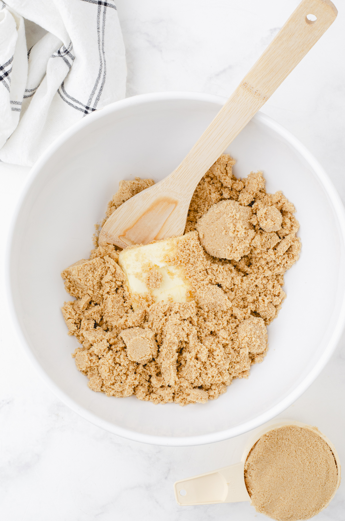 a big white mixing bowl with brown sugar and butter in it for chewy butterscotch brownies recipe