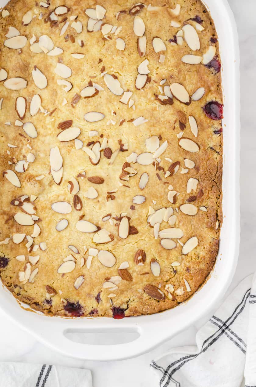 Baked cherry dump cake with sliced almonds on the top.