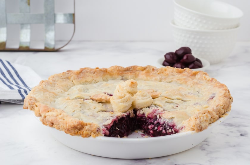 a cherry pie with a slice cut out of it