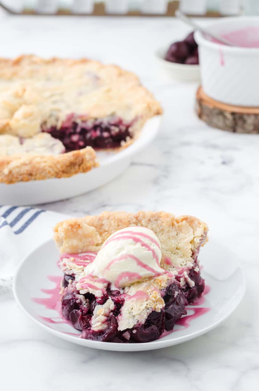 Homemade cherry pie with cherry glaze and ice cream