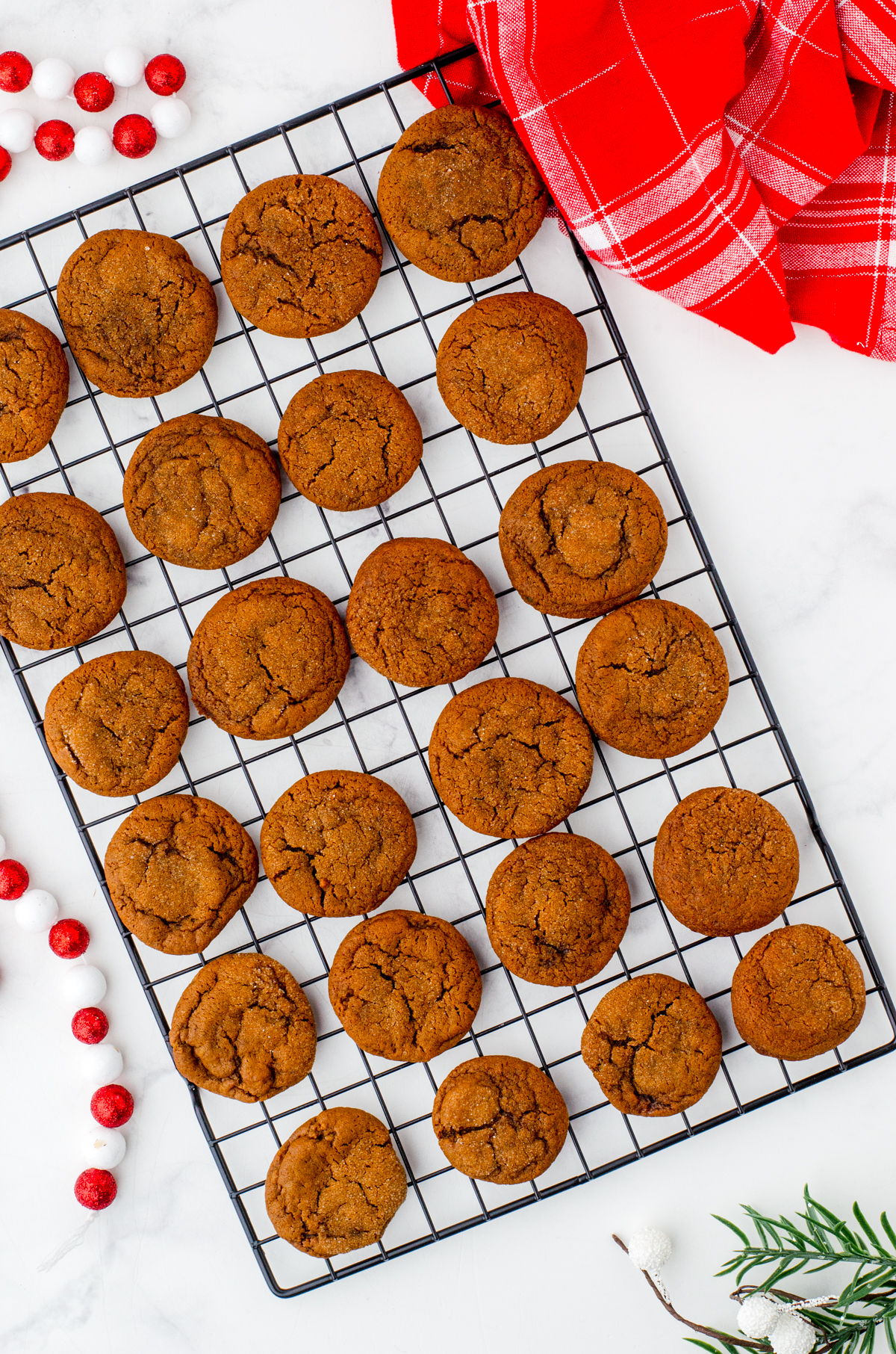 Gingersnaps cookies cooling on a wire baking rack.