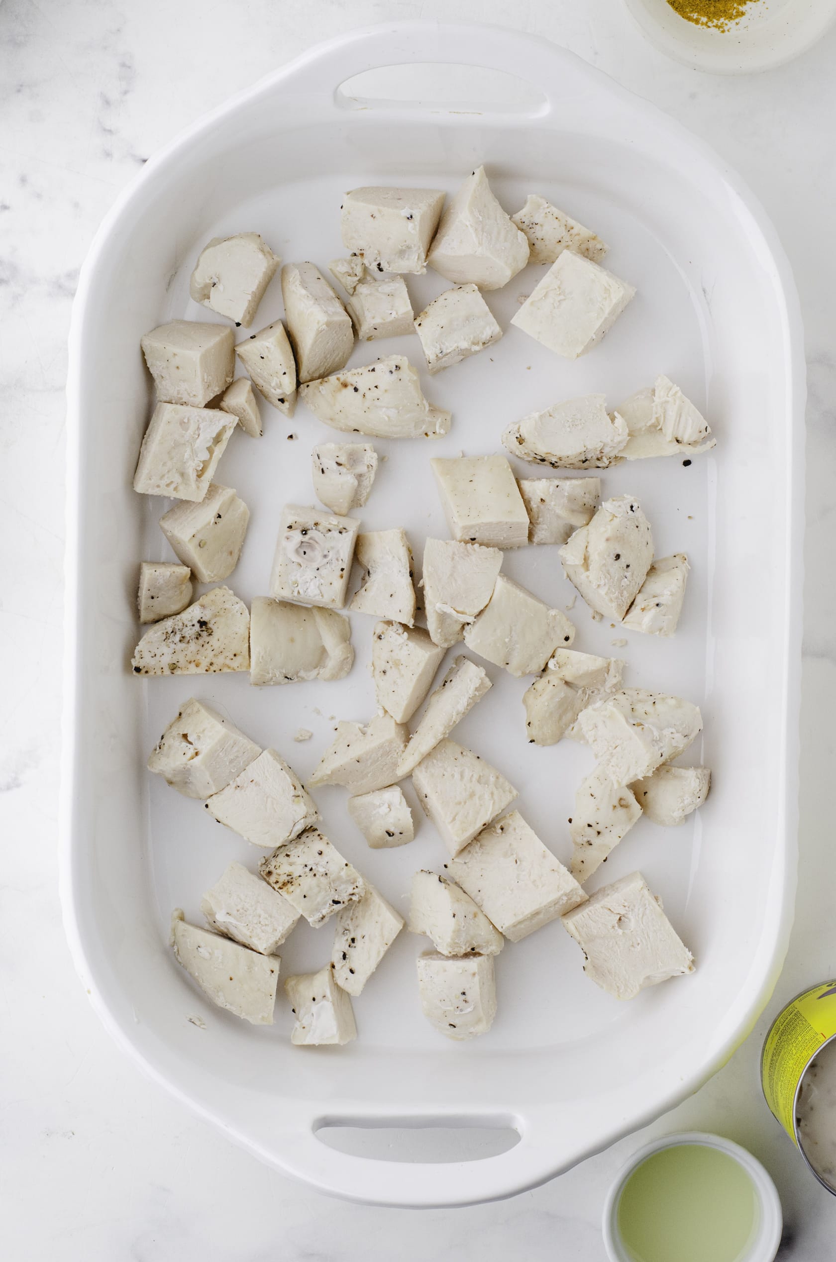 Diced cooked chicken in the bottom of a 9 x 13 inch baking dish