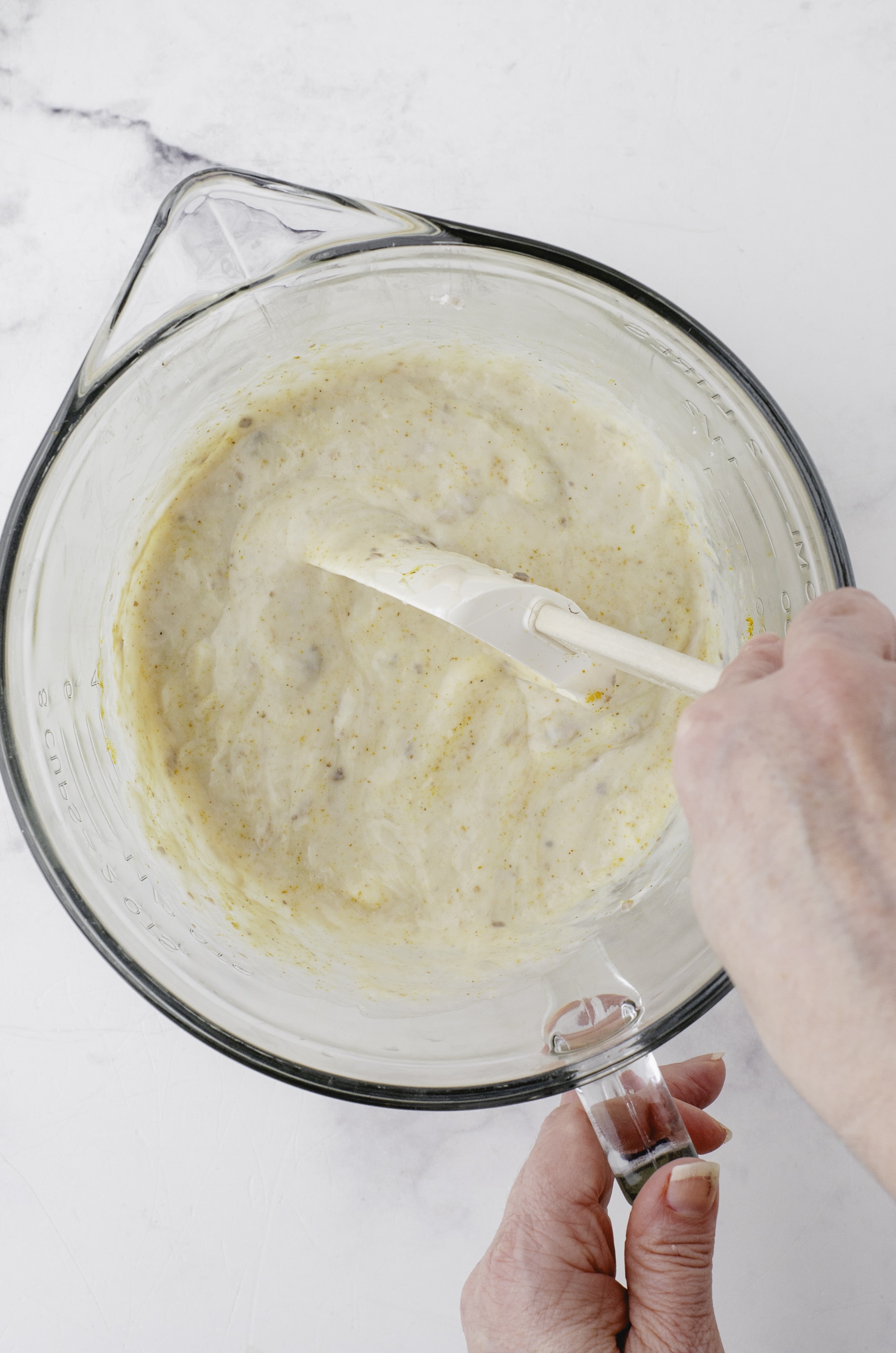 Chicken divan sauce ingredients are mixed in a mixing bowl