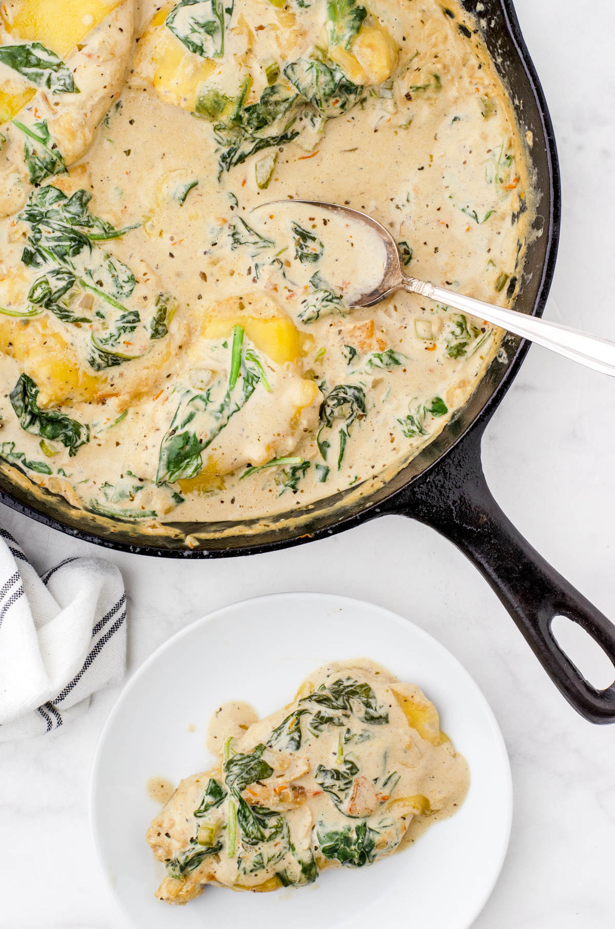 one pan creamy chicken florentine with one serving served out onto a plate.