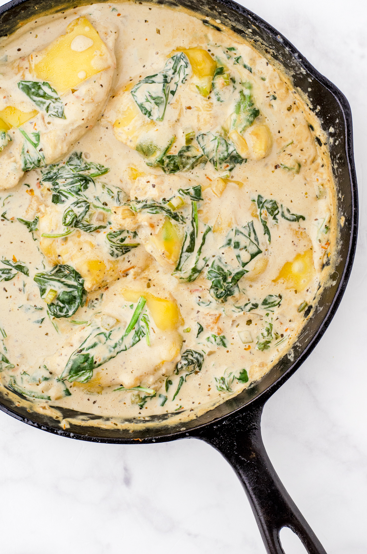 One pan creamy chicken florentine in a cast iron skillet.