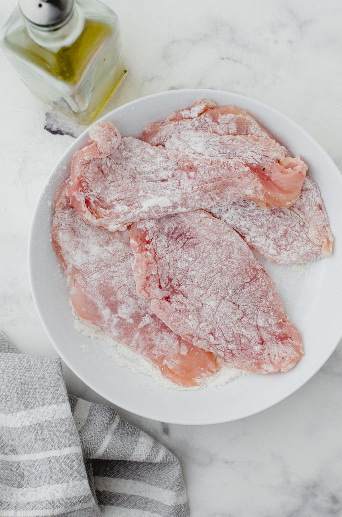Chicken breasts that have been dredged in flour.