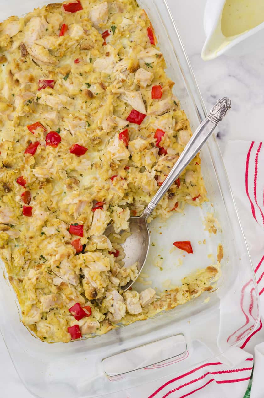 Pan of chicken stuffing casserole with a serving spoon.