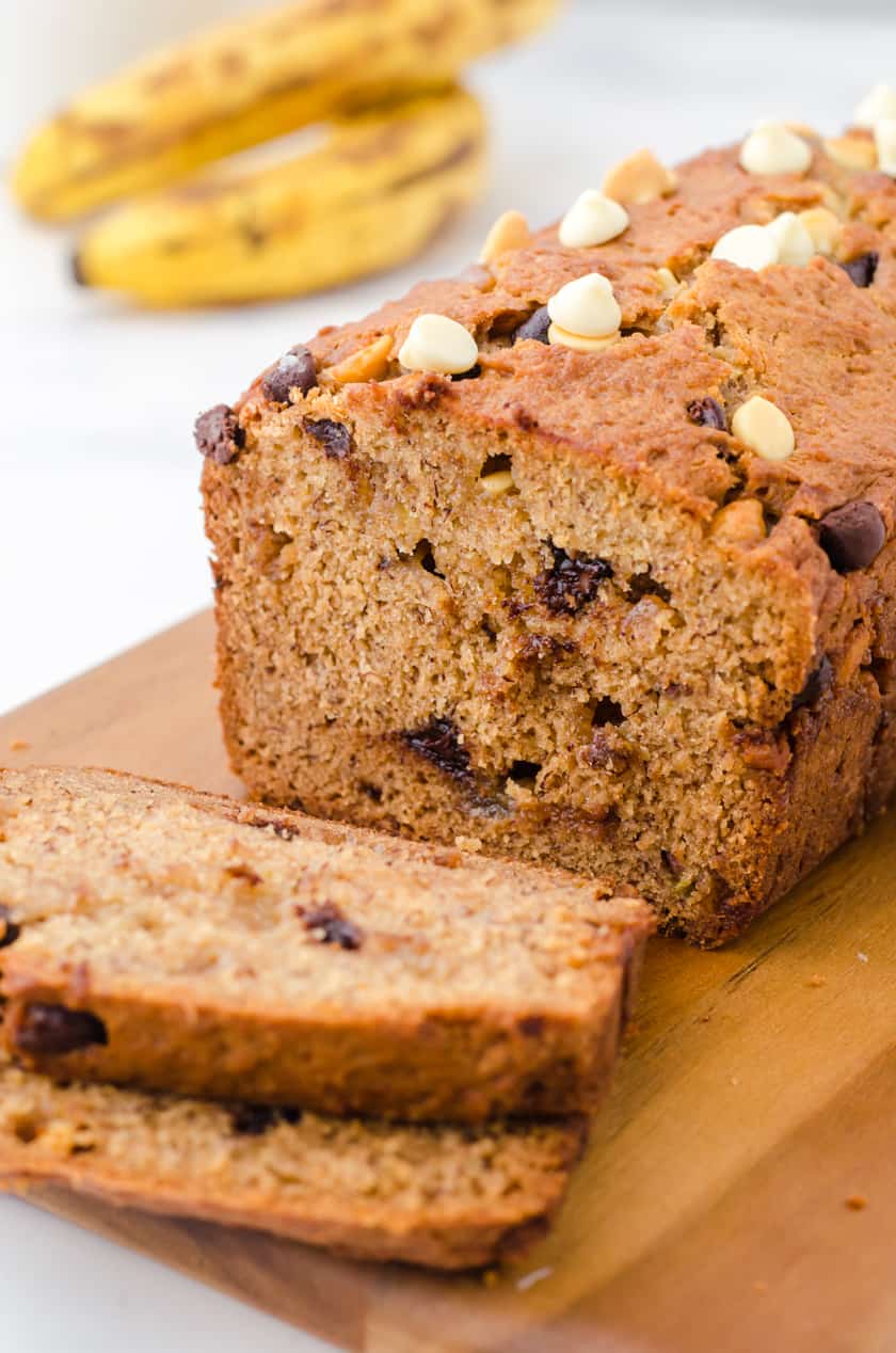 Sliced peanut butter chocolate chip banana bread on a cutting board.