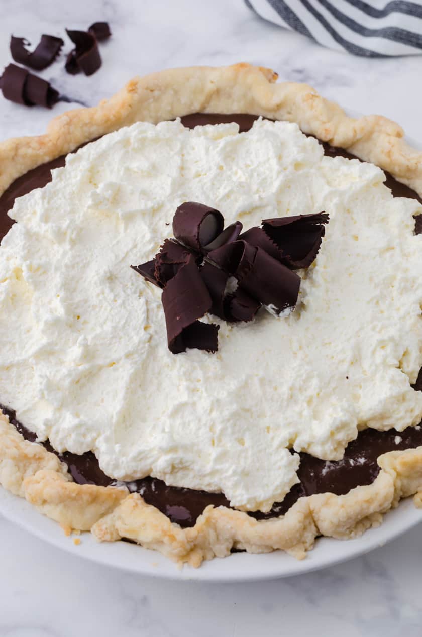 Close up of a whole chocolate cream pie.