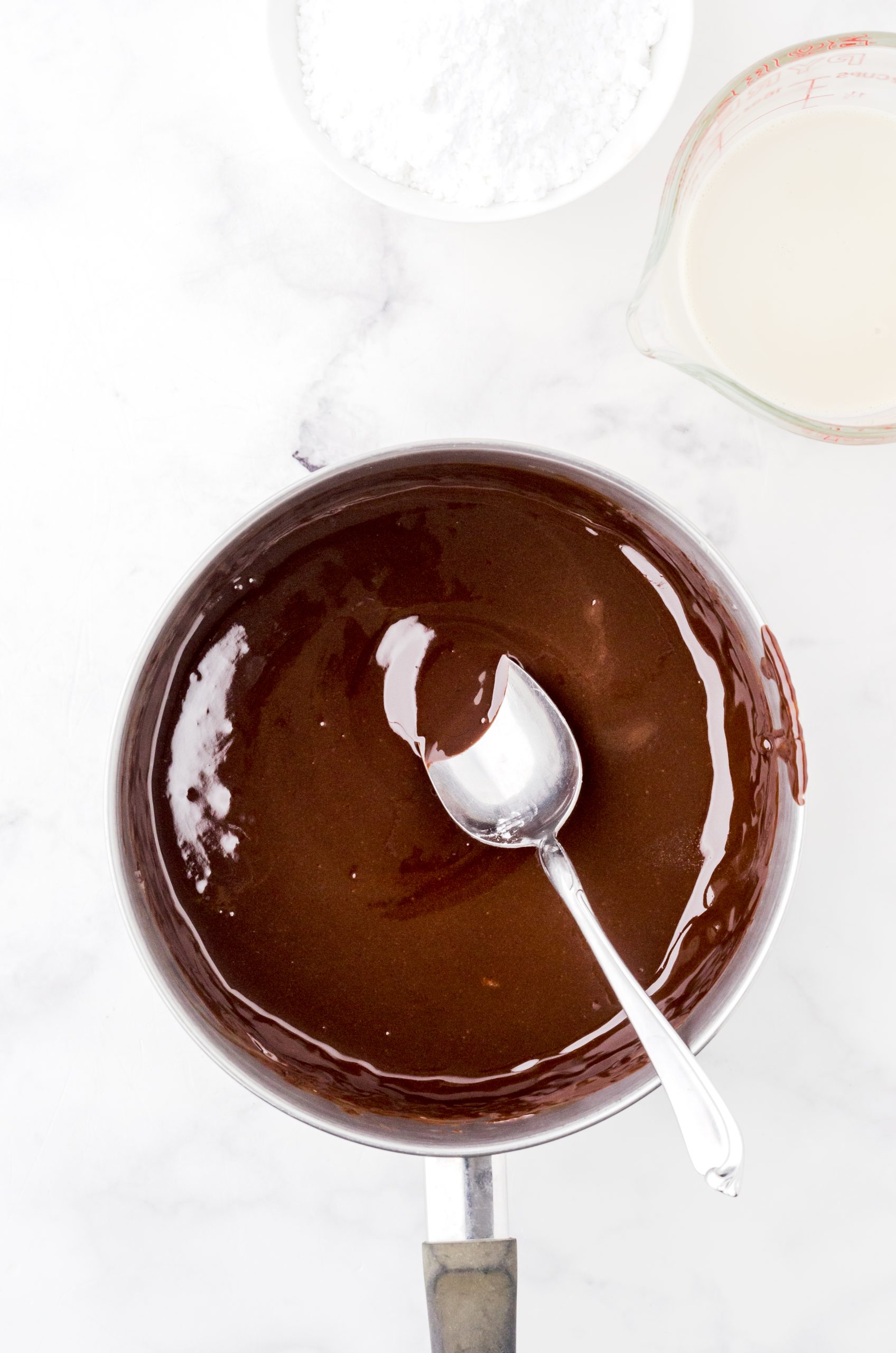 Melted chocolate chips and butter in a saucepan - step 1 for homemade hot fudge sauce