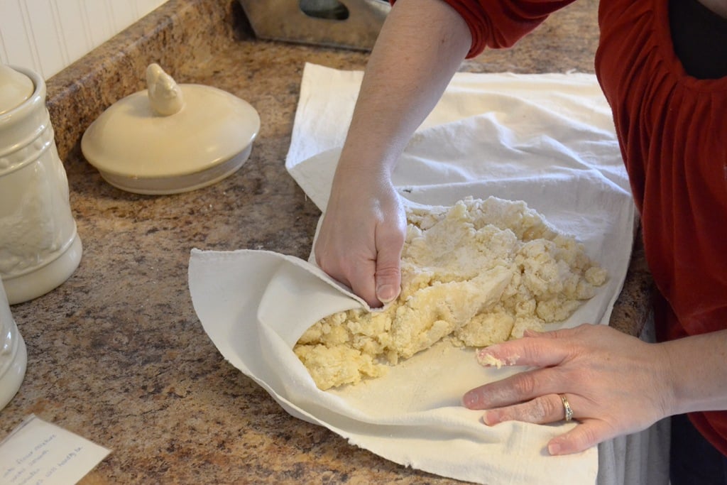 kneading dough together on a pastry cloth