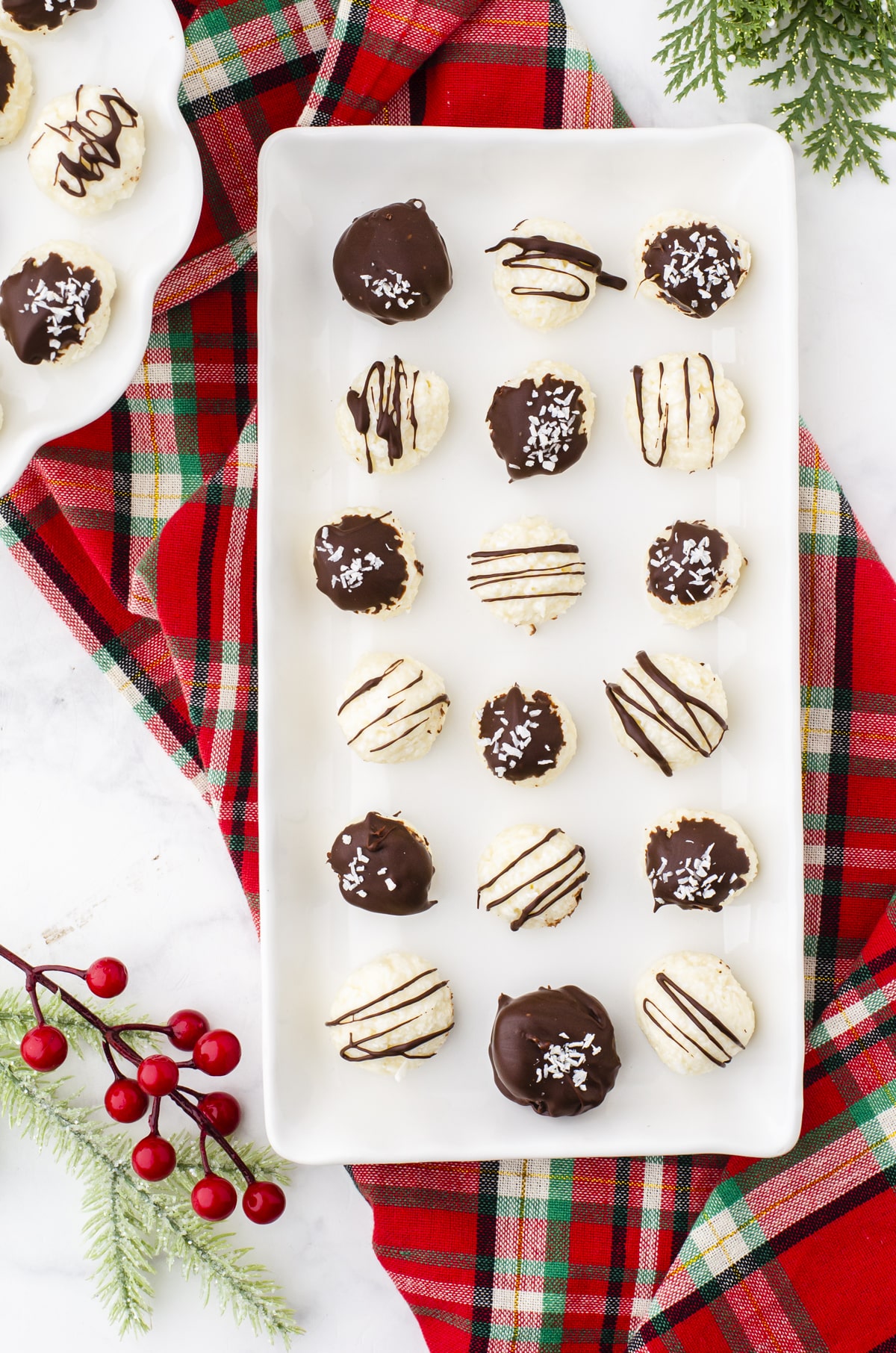 Platter of coconut balls covered with cocolate drizzles and coconut.