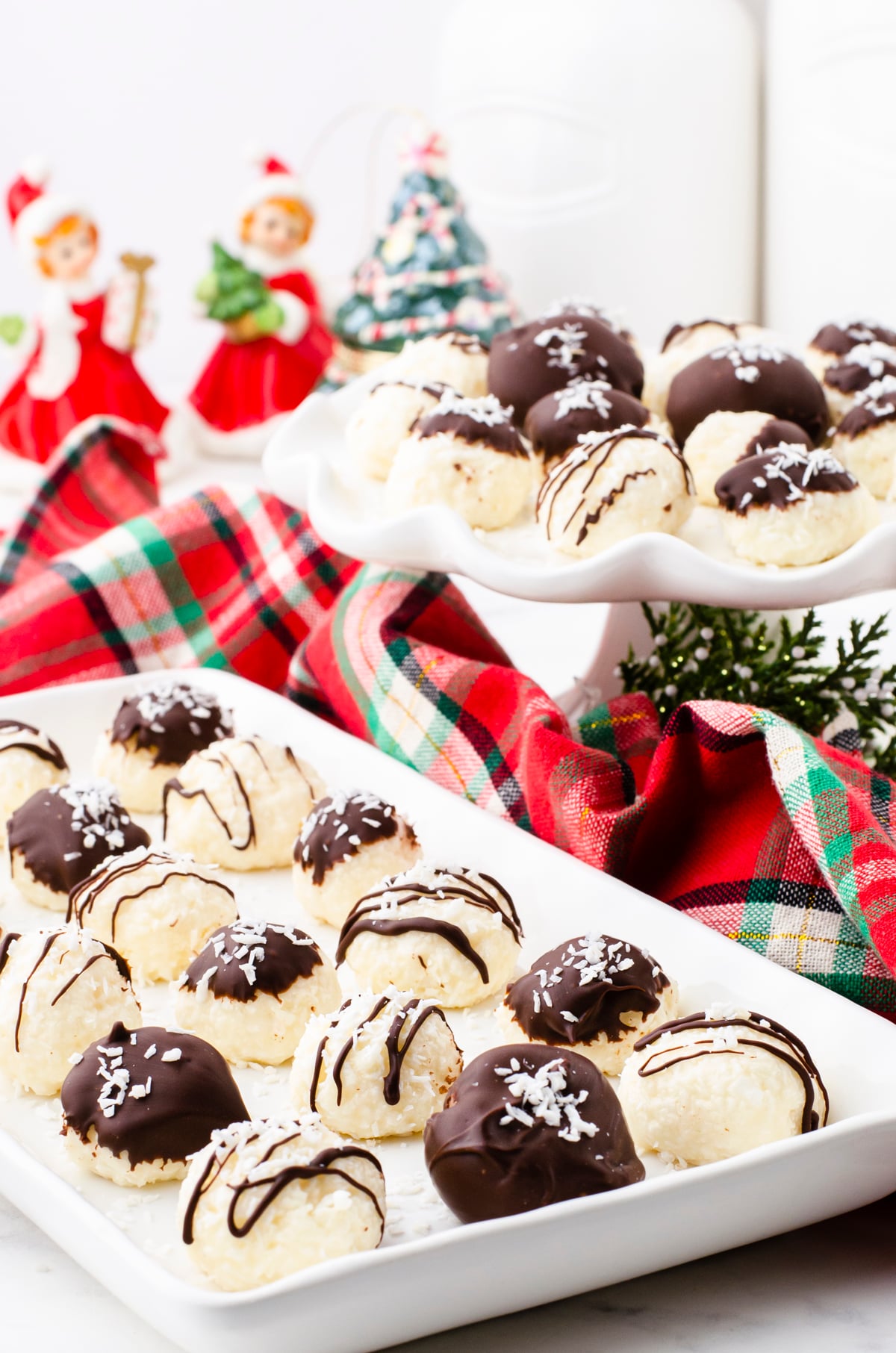 a platter of no bake coconut balls with chocolate