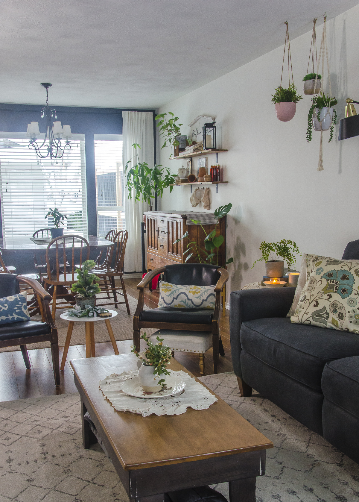 A cottagecore living room and dining room decorated with vintage items.