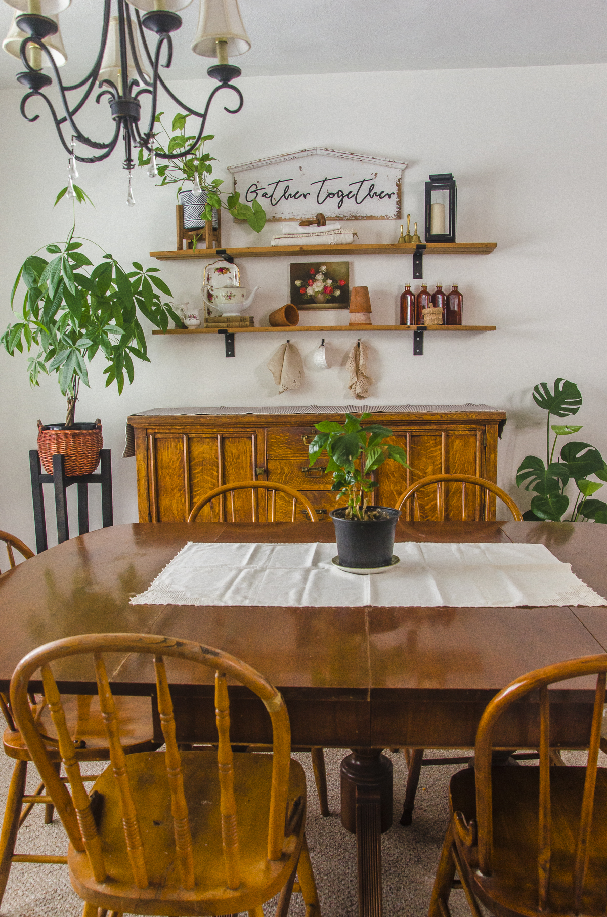 A cottagecore style dining room with cottagecore shelves.